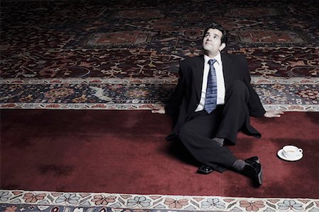 simsearch:630-01191682,k - High angle view of a businessman sitting on a carpet Stock Photo - Premium Royalty-Free, Code: 630-01079749