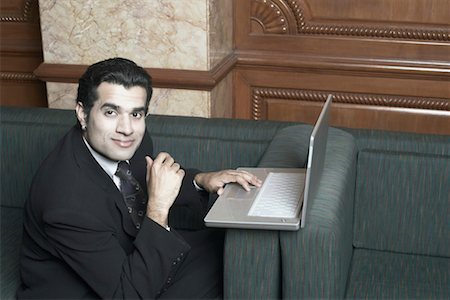 simsearch:630-01191682,k - Portrait of a businessman sitting on a couch with a laptop Stock Photo - Premium Royalty-Free, Code: 630-01079740