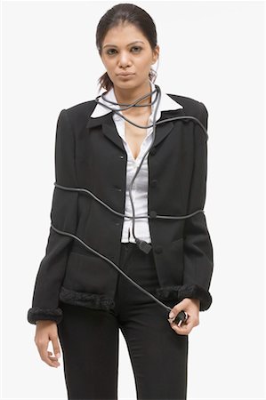 Portrait of a businesswoman with a power chord around her body Stock Photo - Premium Royalty-Free, Code: 630-01080095