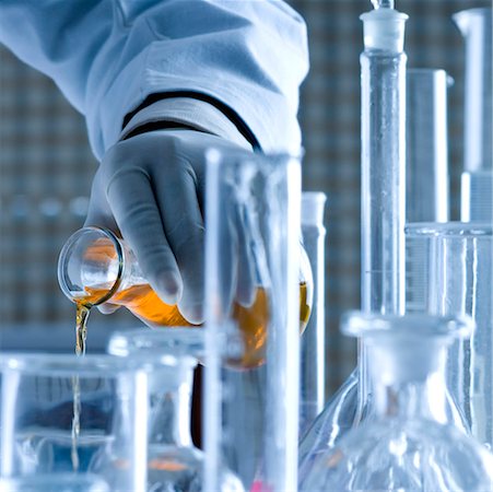 Close-up of a scientist pouring chemicals Stock Photo - Premium Royalty-Free, Code: 630-01080489