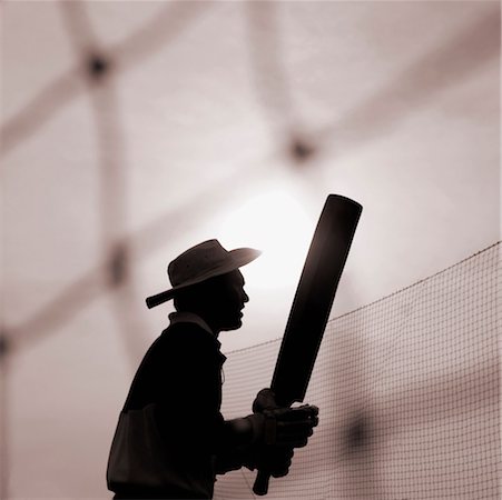 Silhouette of a man holding a cricket bat, Mumbai, Maharashtra, India Stock Photo - Premium Royalty-Free, Code: 630-01126690