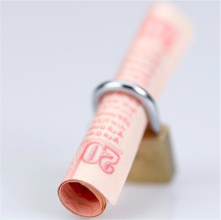 rolled money - High angle view of an Indian twenty rupee banknote in a padlock Stock Photo - Premium Royalty-Free, Code: 630-01126713