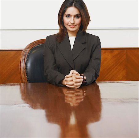 simsearch:630-01130741,k - Portrait of a businesswoman sitting in a conference room with her hands clasped Stock Photo - Premium Royalty-Free, Code: 630-01126994