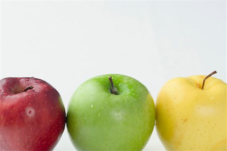 Close-up of three apples in a row Foto de stock - Sin royalties Premium, Código: 630-01127365