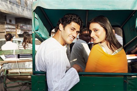 rickshaw - Portrait of a young couple sitting in a rickshaw and smiling Stock Photo - Premium Royalty-Free, Code: 630-01127566