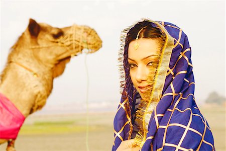 simsearch:630-01130737,k - Close-up of a young woman with a camel in the background Stock Photo - Premium Royalty-Free, Code: 630-01127589