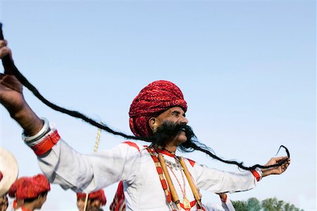 elephant festival - Low angle view of a mature man holding his mustaches, Elephant Festival, Jaipur, Rajasthan, India Stock Photo - Premium Royalty-Free, Code: 630-01127725