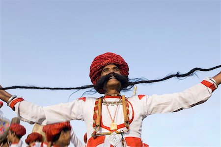 elephant festival - Low angle view of a mature man holding his mustache, Elephant Festival, Jaipur, Rajasthan, India Stock Photo - Premium Royalty-Free, Code: 630-01127726