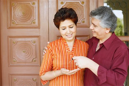 retired indian couple - Close-up of a mature man giving car keys to a mature woman Stock Photo - Premium Royalty-Free, Code: 630-01128241