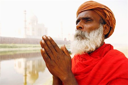 Close-up of a priest standing in a prayer position on the riverbank, Taj Mahal, Agra, Uttar Pradesh, India Stock Photo - Premium Royalty-Free, Code: 630-01128644