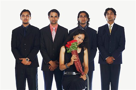 simsearch:630-01128982,k - Portrait of a young woman holding a bouquet of flowers with four businessmen standing behind her Stock Photo - Premium Royalty-Free, Code: 630-01128648