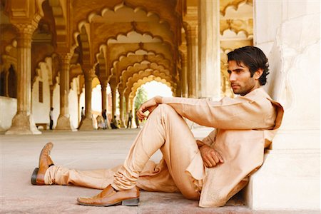 Side profile of a young man sitting on the floor, Agra Fort, Agra, Uttar Pradesh, India Stock Photo - Premium Royalty-Free, Code: 630-01128660