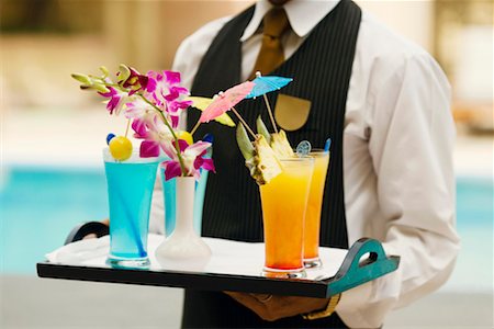 Mid section view of a waiter holding a tray of drinks Stock Photo - Premium Royalty-Free, Code: 630-01128687