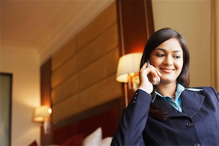 simsearch:630-01128810,k - Low angle view of a businesswoman talking on a mobile phone Stock Photo - Premium Royalty-Free, Code: 630-01128758