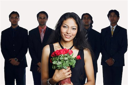 simsearch:630-01128784,k - Portrait of a young woman holding a bouquet of flowers with four businessmen standing behind her Stock Photo - Premium Royalty-Free, Code: 630-01128802