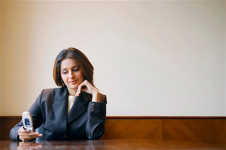 simsearch:630-01131251,k - Close-up of a businesswoman using a mobile phone in a conference room Foto de stock - Sin royalties Premium, Código: 630-01128810