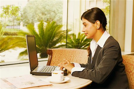 simsearch:630-01130741,k - Side profile of a businesswoman working on a laptop Stock Photo - Premium Royalty-Free, Code: 630-01128821