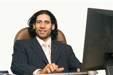 simsearch:630-01076251,k - Portrait of a businessman sitting in front of a computer Stock Photo - Premium Royalty-Free, Code: 630-01128854