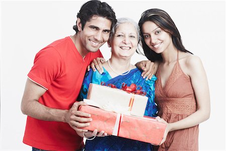 simsearch:630-01131551,k - Portrait of a mature woman holding gifts with her two grandchildren Stock Photo - Premium Royalty-Free, Code: 630-01128880