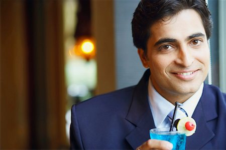 Portrait of a businessman holding a glass of cocktail Stock Photo - Premium Royalty-Free, Code: 630-01128934