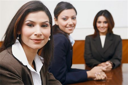 simsearch:630-01128982,k - Portrait of three businesswomen sitting in a conference room Stock Photo - Premium Royalty-Free, Code: 630-01128987
