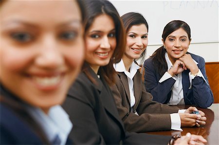 simsearch:630-01128982,k - Portrait of four businesswomen sitting in a conference room Stock Photo - Premium Royalty-Free, Code: 630-01128997