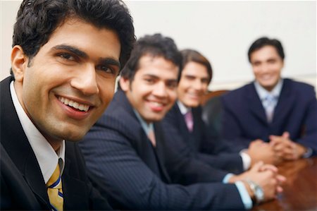simsearch:630-01128454,k - Portrait of four businessmen sitting in a conference room Stock Photo - Premium Royalty-Free, Code: 630-01128993