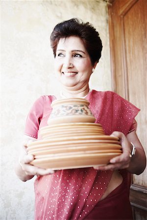 simsearch:630-01131008,k - Close-up of a mature woman holding a stack of plates Foto de stock - Sin royalties Premium, Código: 630-01129575