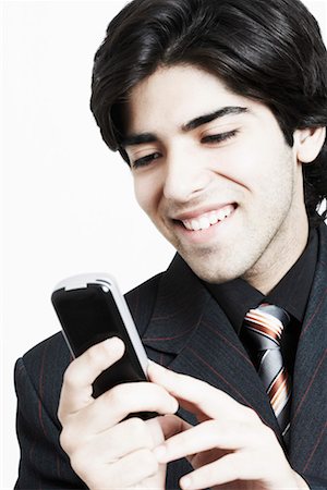simsearch:630-01128257,k - Close-up of a businessman operating a mobile phone Stock Photo - Premium Royalty-Free, Code: 630-01130005