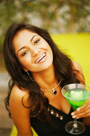 simsearch:630-01130529,k - Portrait of a young woman holding a glass of cocktail Stock Photo - Premium Royalty-Free, Code: 630-01130344