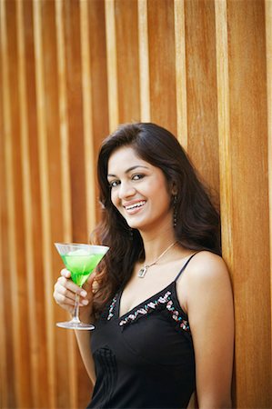 simsearch:630-01128103,k - Portrait of a young woman holding a glass of cocktail Stock Photo - Premium Royalty-Free, Code: 630-01130421