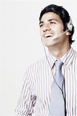 simsearch:630-01078367,k - Close-up of a businessman wearing headphones Foto de stock - Sin royalties Premium, Código: 630-01130494