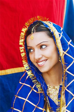 elephant indian costume - Close-up of a young woman smiling Stock Photo - Premium Royalty-Free, Code: 630-01130756