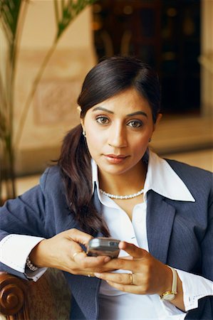 simsearch:630-01128810,k - Portrait of a businesswoman holding a mobile phone Stock Photo - Premium Royalty-Free, Code: 630-01130805