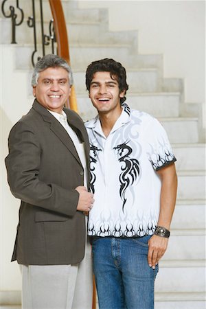 Portrait of a mature man and his son smiling Stock Photo - Premium Royalty-Free, Code: 630-01130823