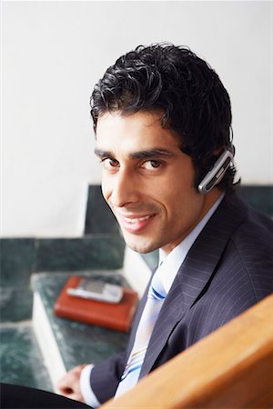 simsearch:640-02950930,k - Portrait of a businessman wearing a hands free device and smiling Stock Photo - Premium Royalty-Free, Code: 630-01130933