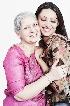 saree hug images - Portrait of a mature woman hugging her granddaughter Stock Photo - Premium Royalty-Free, Code: 630-01131051