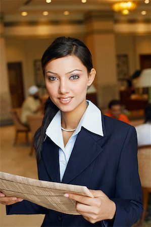 simsearch:630-01130741,k - Portrait of a businesswoman holding a newspaper Stock Photo - Premium Royalty-Free, Code: 630-01131104