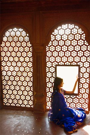 Side profile of a young woman sitting on the floor of a mausoleum, Taj Mahal, Agra, Uttar Pradesh, India Stock Photo - Premium Royalty-Free, Code: 630-01131107