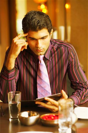 simsearch:630-01130741,k - Close-up of a businessman looking at a menu in a restaurant Stock Photo - Premium Royalty-Free, Code: 630-01131116
