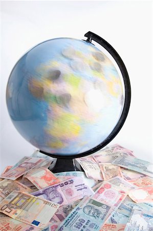 High angle view of a globe on a heap of Indian banknotes and Euro banknotes Stock Photo - Premium Royalty-Free, Code: 630-01131137