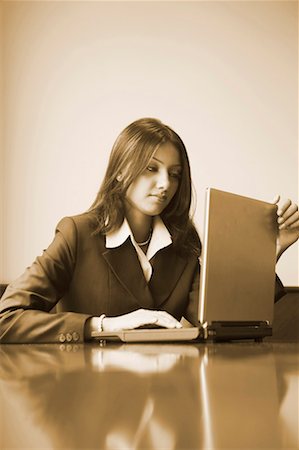 simsearch:630-01128810,k - Businesswoman using a laptop in an office Stock Photo - Premium Royalty-Free, Code: 630-01131151