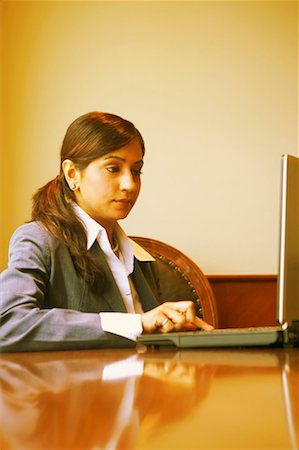 simsearch:630-01128810,k - Businesswoman using a laptop in an office Stock Photo - Premium Royalty-Free, Code: 630-01131208