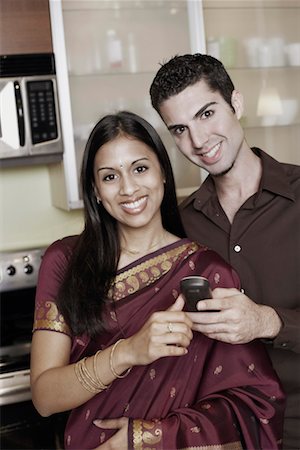 simsearch:630-01128006,k - Portrait of a young couple holding a mobile phone Stock Photo - Premium Royalty-Free, Code: 630-01131209
