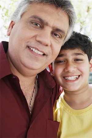 Portrait of a mature man and his grandson smiling Stock Photo - Premium Royalty-Free, Code: 630-01131217