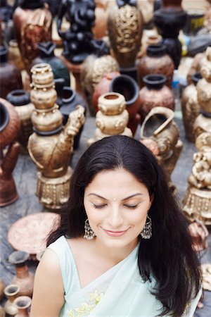 High angle view of a young woman standing with her eyes closed in a pottery store Stock Photo - Premium Royalty-Free, Code: 630-01131256