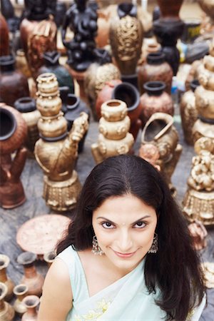 Portrait of a young woman smiling in a pottery store Stock Photo - Premium Royalty-Free, Code: 630-01131320