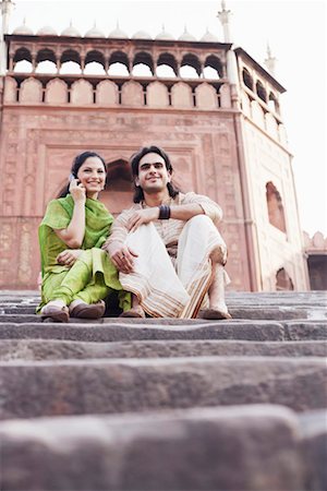 simsearch:630-01128006,k - Low angle view of a young couple sitting on the steps in front of a building, Jama Masjid, Delhi, India Stock Photo - Premium Royalty-Free, Code: 630-01131403