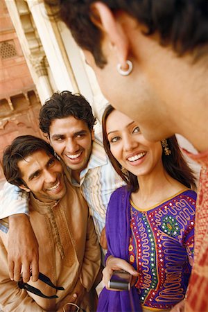 simsearch:630-01128006,k - Close-up of three young men and a young woman smiling, Agra, Uttar Pradesh, India Stock Photo - Premium Royalty-Free, Code: 630-01131445