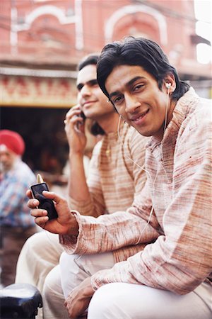 Two young men sitting in a rickshaw Stock Photo - Premium Royalty-Free, Code: 630-01131555